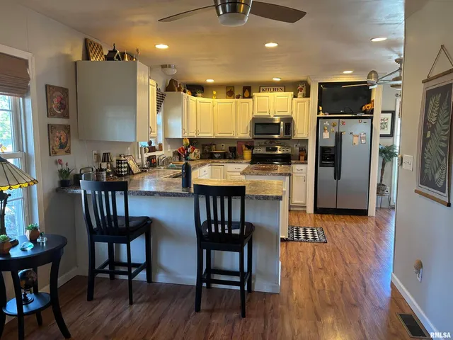 a room with lots of chairs and wooden floor