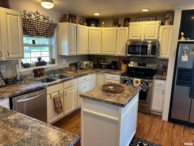 a bedroom with bed and wooden floor