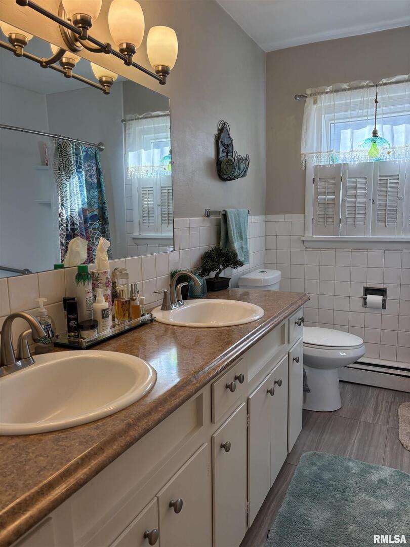 210 Apple Lane Anna, IL 62906 - Photo 33 of 45 a bathroom with a granite countertop sink a toilet and mirror