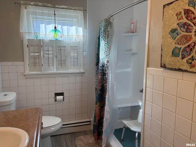 a bathroom with a double vanity sink toilet and a mirror