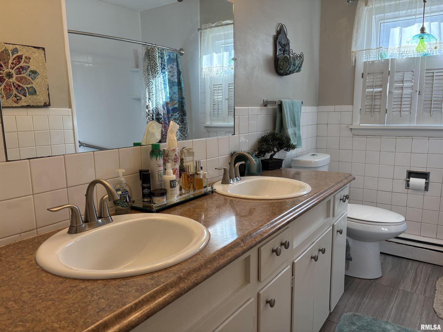 210 Apple Lane Anna, IL 62906 - Photo 35 of 45 a bathroom with a double vanity sink toilet and a mirror