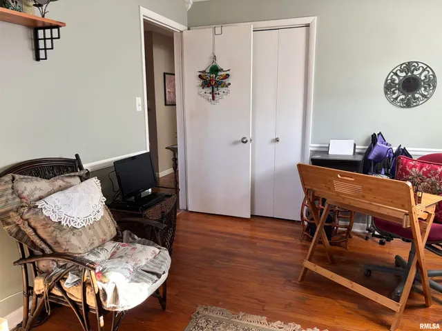 a view of a workspace with furniture and a window