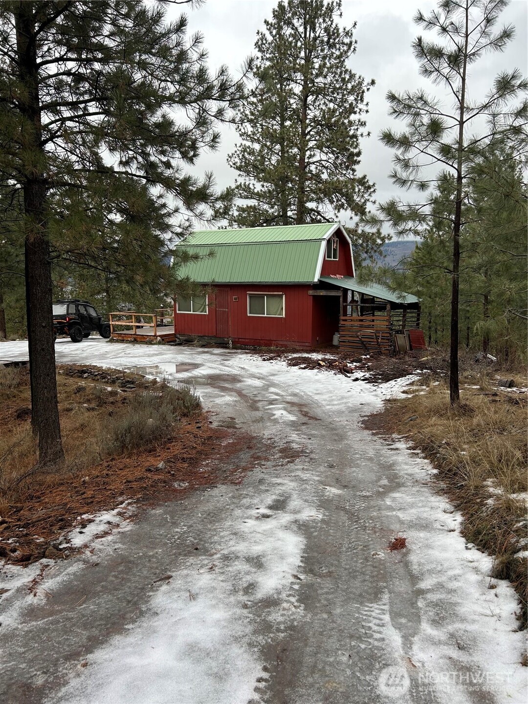 315 Reevas Basin Road Tonasket, WA 98855 - Photo 3 of 25 a view of a barn in the middle of a yard