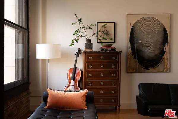 a view of a livingroom with furniture and a mirror