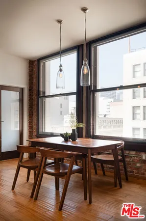 a room with a large window and wooden floor