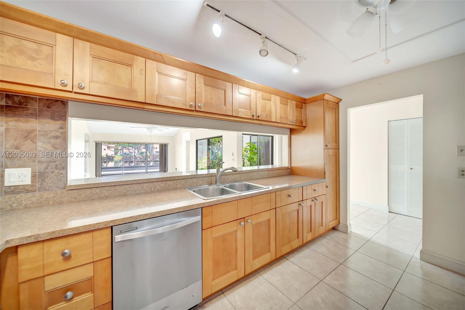 5223 Gate Lake Road, Unit 5223 Tamarac, FL 33319 - Photo 13 of 37 a kitchen with a sink and cabinets