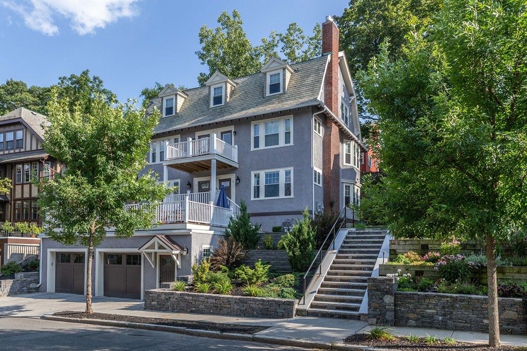 135 University Road, Unit 1 Brookline, MA 02445 - Photo 1 of 18 a front view of a house with trees