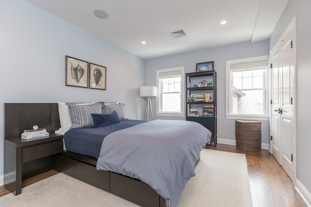 135 University Road, Unit 1 Brookline, MA 02445 - Photo 12 of 18 a bedroom with a large bed and a window