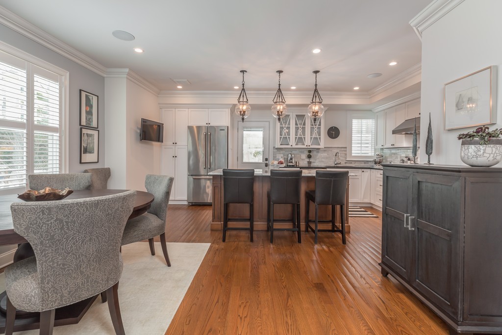 135 University Road, Unit 1 Brookline, MA 02445 - Photo 4 of 18 a dining room with stainless steel appliances kitchen island granite countertop furniture a large window and kitchen view