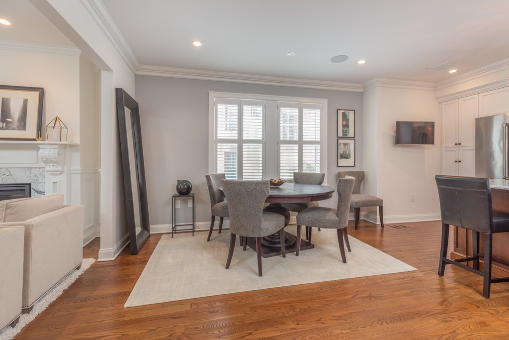135 University Road, Unit 1 Brookline, MA 02445 - Photo 5 of 18 a view of a dining room with furniture and wooden floor