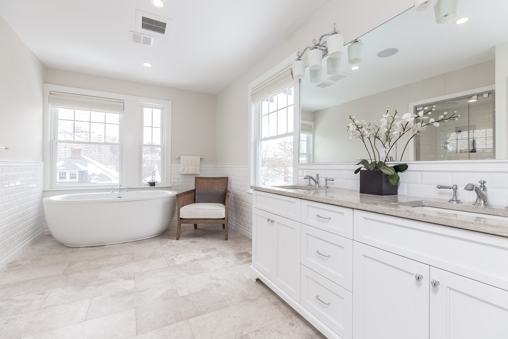 135 University Road, Unit 1 Brookline, MA 02445 - Photo 8 of 18 a spacious bathroom with a double vanity sink a bathtub and window