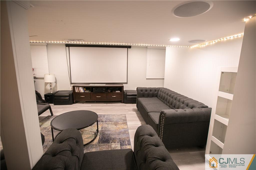 4308 Hana Road Edison, NJ 08817 - Photo 16 of 32 a living room with furniture and a flat screen tv