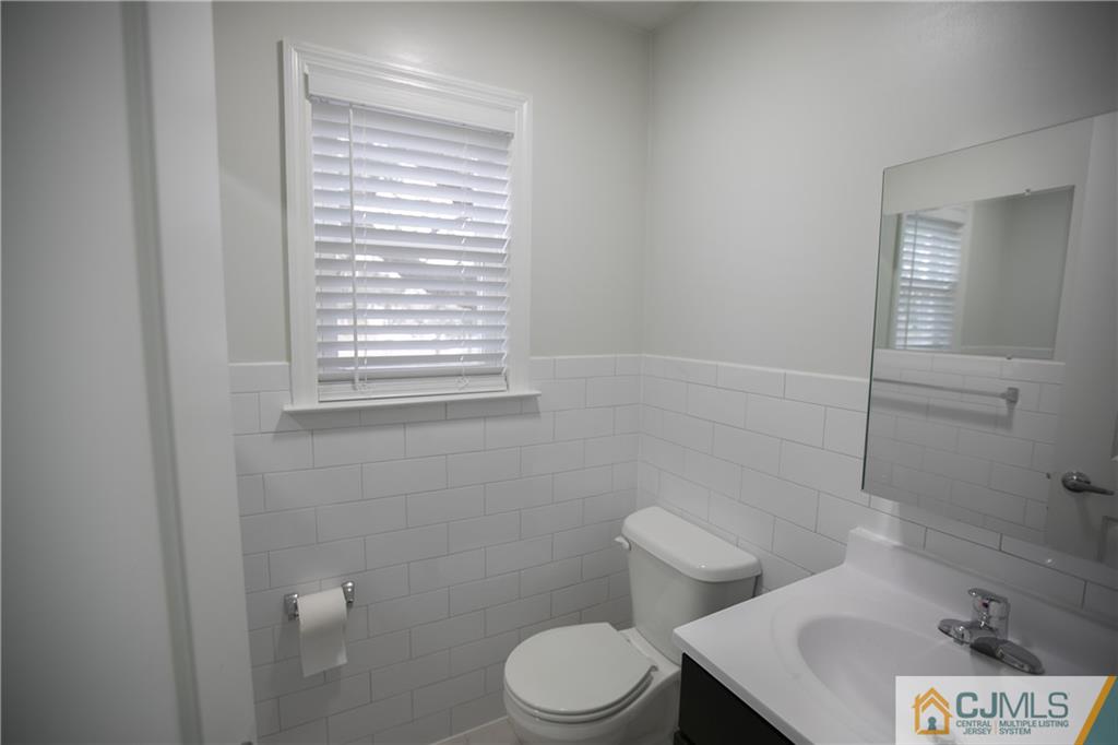 4308 Hana Road Edison, NJ 08817 - Photo 19 of 32 a white toilet sitting next to a bathroom sink