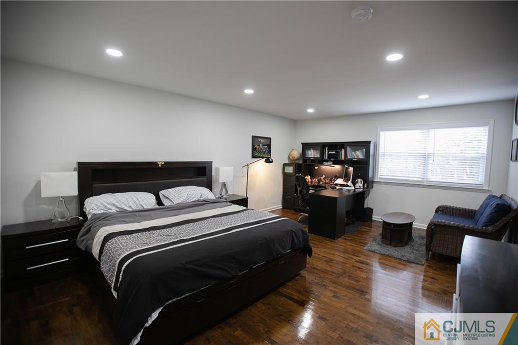 4308 Hana Road Edison, NJ 08817 - Photo 21 of 32 a bedroom with bed mirror and window