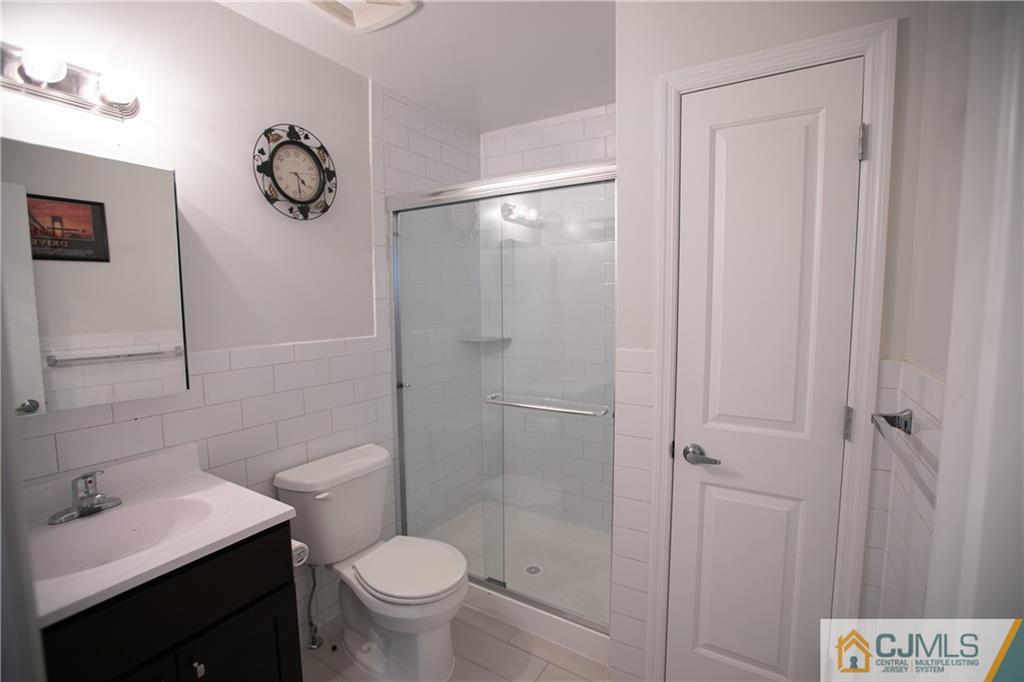 4308 Hana Road Edison, NJ 08817 - Photo 24 of 32 a bathroom with a shower sink vanity mirror and toilet
