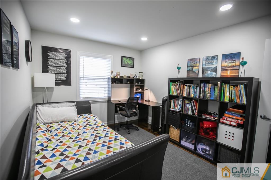 4308 Hana Road Edison, NJ 08817 - Photo 27 of 32 a bedroom with a bed and a book shelf