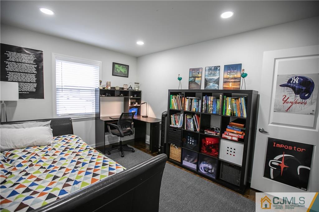 4308 Hana Road Edison, NJ 08817 - Photo 28 of 32 a bedroom with furniture and a book shelf