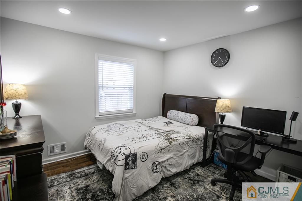 4308 Hana Road Edison, NJ 08817 - Photo 29 of 32 a bedroom with a bed and a window