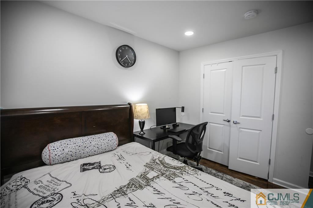 4308 Hana Road Edison, NJ 08817 - Photo 31 of 32 a bedroom with a bed and a table in it