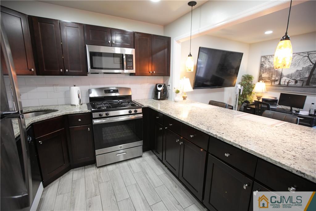 4308 Hana Road Edison, NJ 08817 - Photo 6 of 32 a kitchen with a sink stove and microwave
