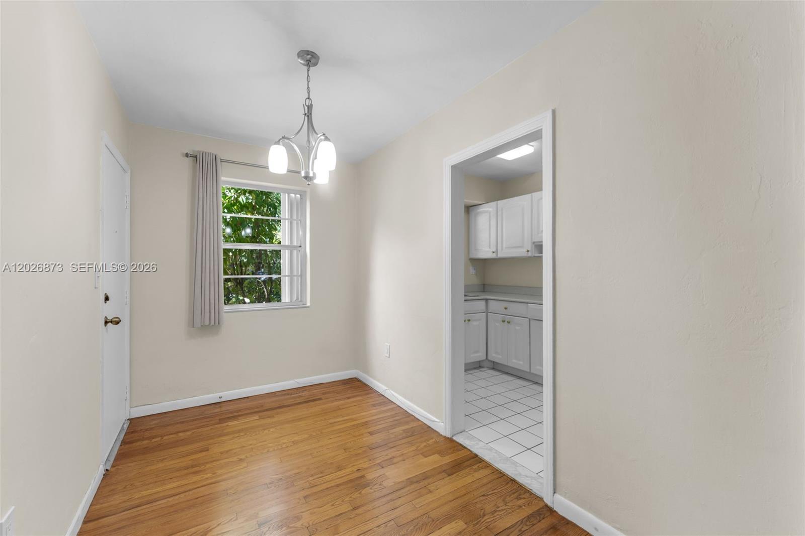 5590 Southwest 78th Street, Unit 133B Miami, FL 33143 - Photo 4 of 18 wooden floor in an empty room with a window