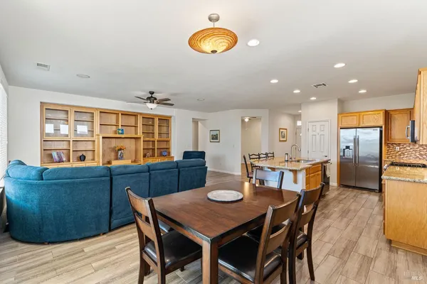 a view of a dining room with furniture and wooden floor