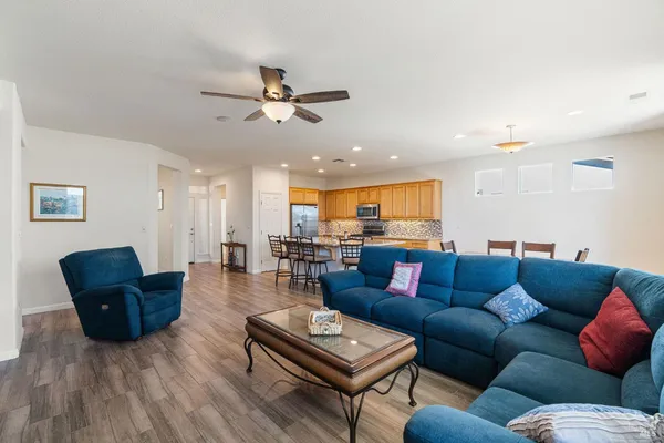 a view of a livingroom with a ceiling fan and window
