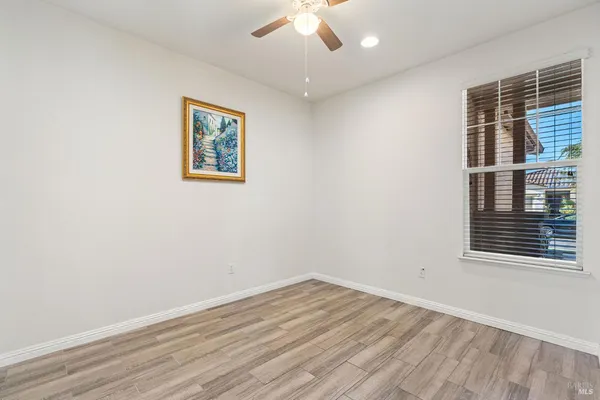 a view of a livingroom with a ceiling fan and window