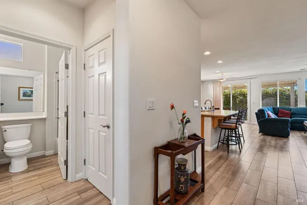 a kitchen with a table chairs stove and wooden floor