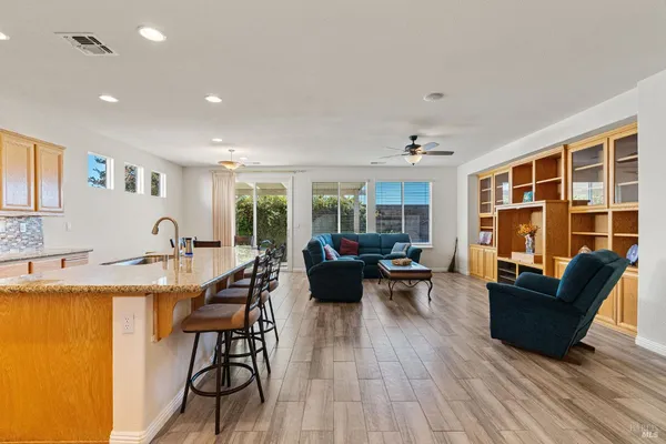 a kitchen with a table chairs microwave and cabinets