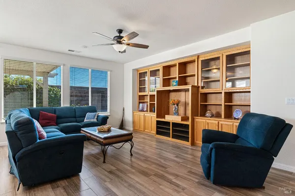 a kitchen with stainless steel appliances granite countertop a table and chairs with wooden floor