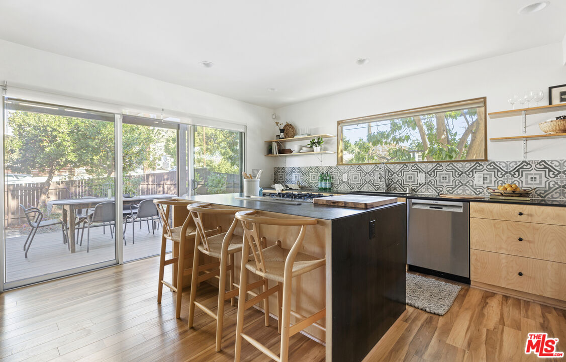 5740 Meridian Street Los Angeles, CA 90042 - Photo 19 of 50 a kitchen with a table chairs stove and wooden floor