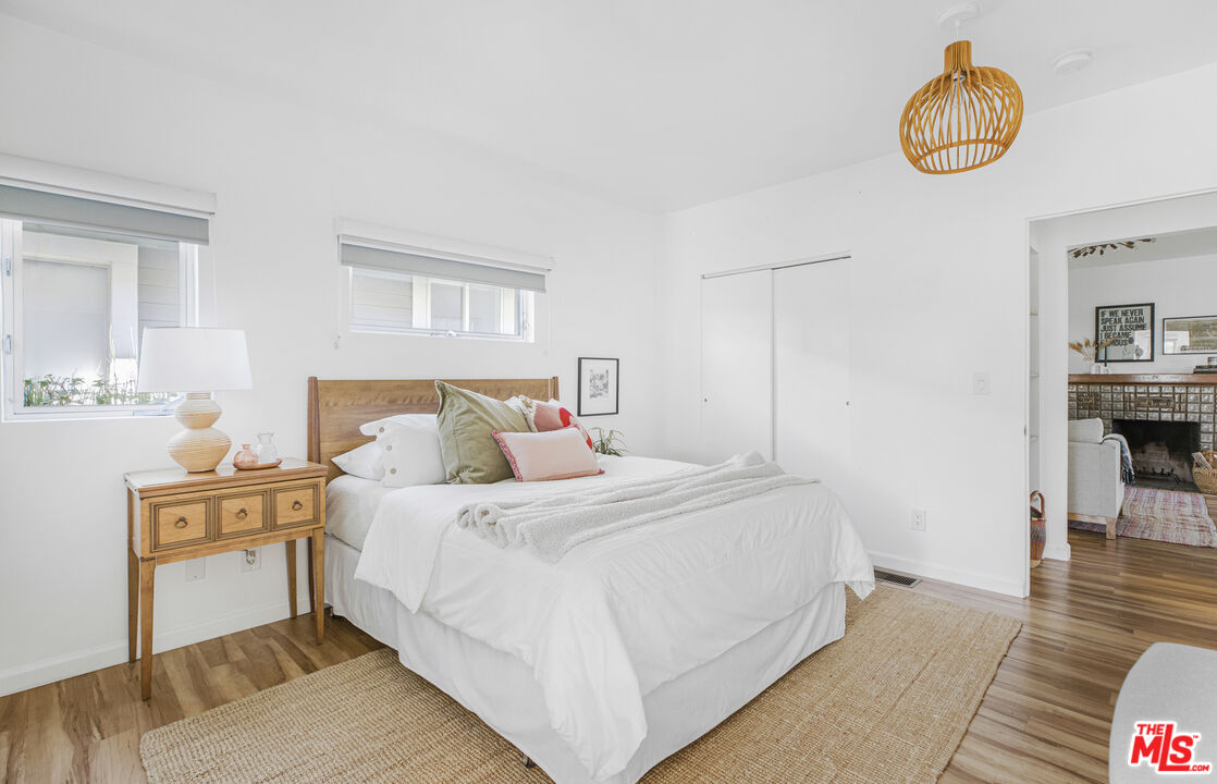 5740 Meridian Street Los Angeles, CA 90042 - Photo 31 of 50 a bedroom with a bed and a chandelier