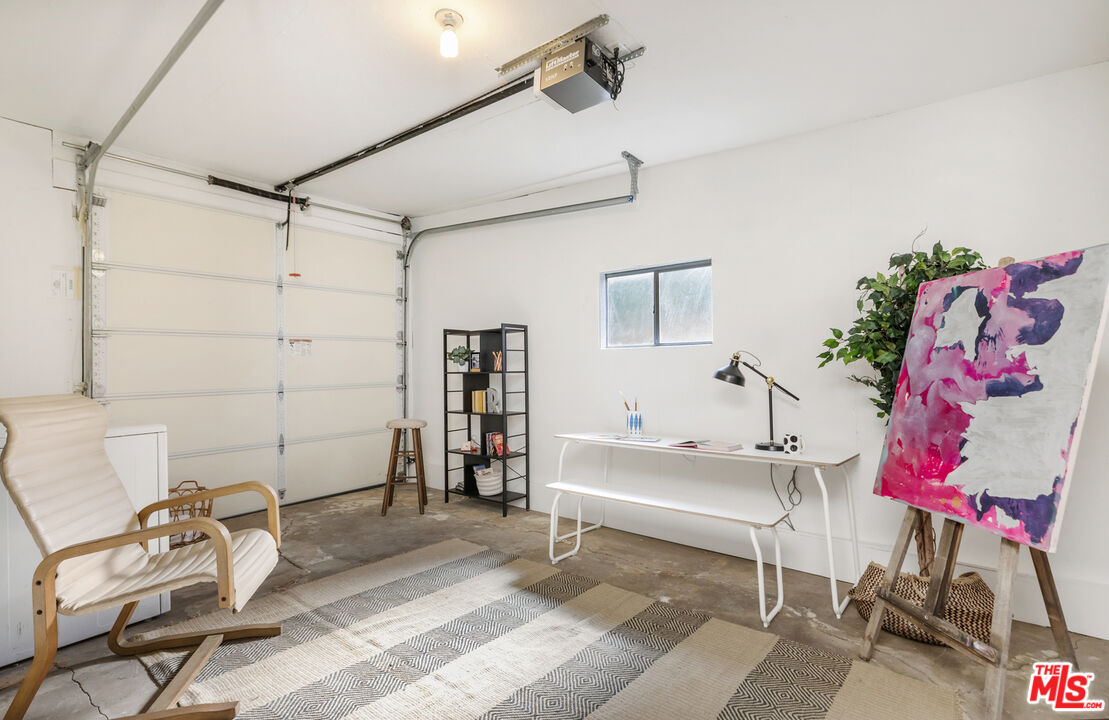 5740 Meridian Street Los Angeles, CA 90042 - Photo 46 of 50 a bedroom with a bed and a chair