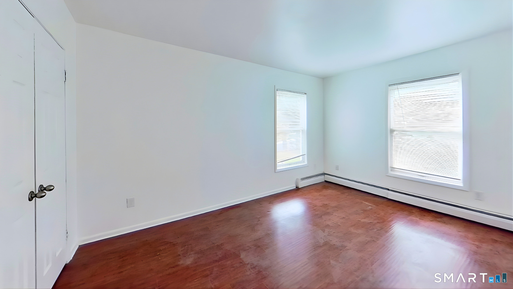 72 Chestnut Street, Unit 6 Norwalk, CT 06854 - Photo 5 of 14 an empty room with wooden floor and windows