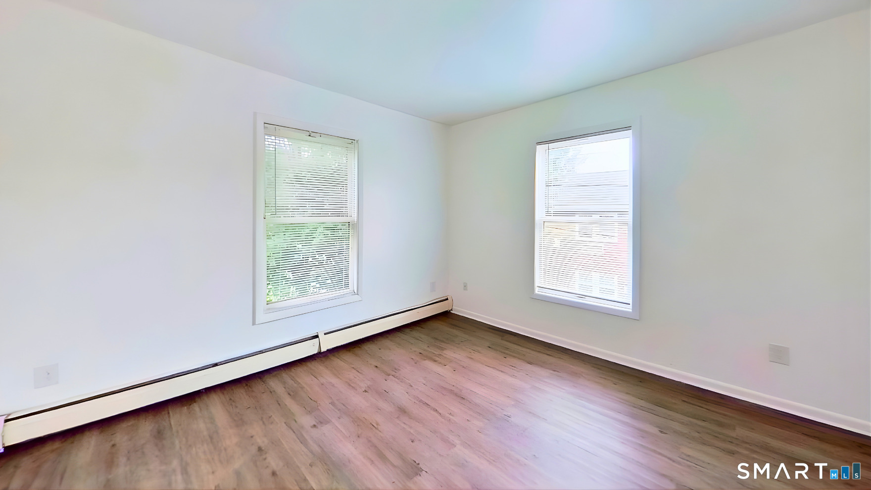 72 Chestnut Street, Unit 6 Norwalk, CT 06854 - Photo 6 of 14 an empty room with wooden floor and windows