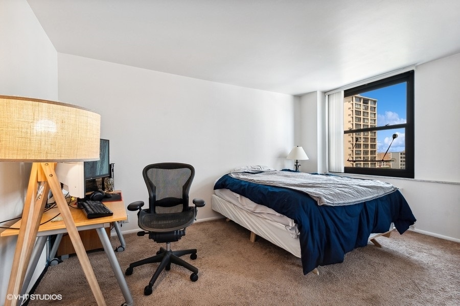 5701 North Sheridan Road, Unit 9L Chicago, IL 60660 - Photo 11 of 17 a bedroom with a bed a desk and chair