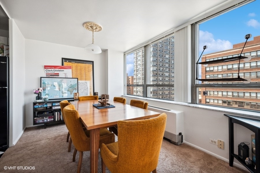 5701 North Sheridan Road, Unit 9L Chicago, IL 60660 - Photo 5 of 17 a dining room with stainless steel appliances granite countertop a stove and a dining table with the kitchen view