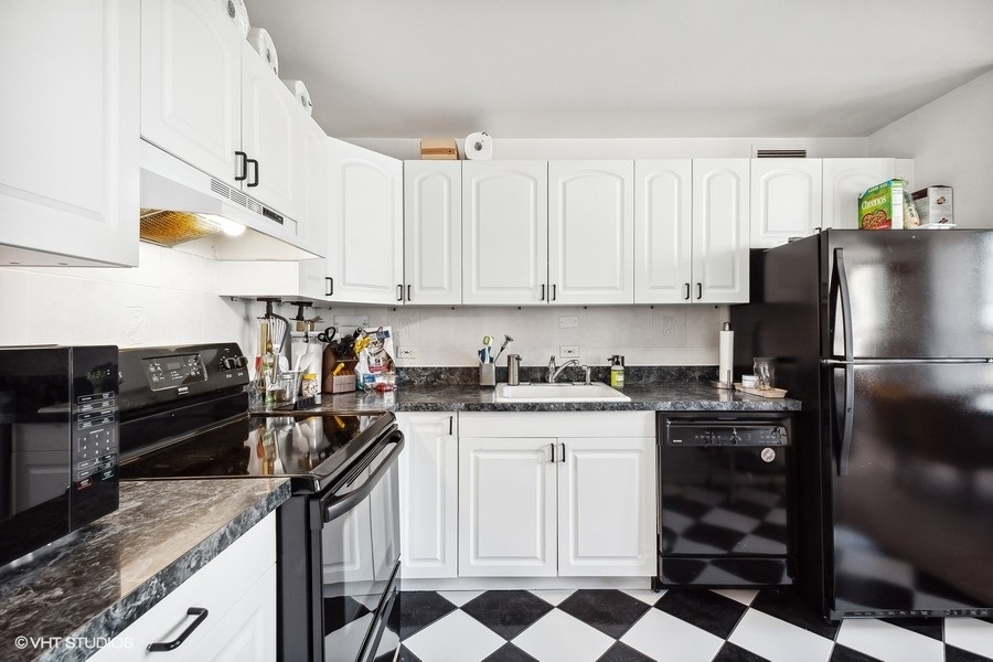 5701 North Sheridan Road, Unit 9L Chicago, IL 60660 - Photo 8 of 17 a kitchen with granite countertop a sink stove and refrigerator