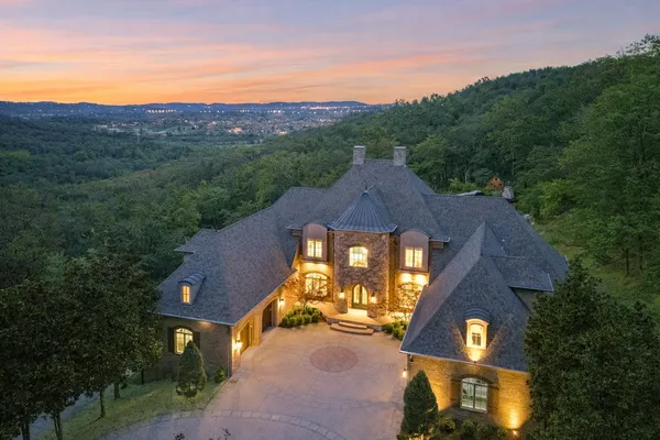 an aerial view of a house with a big yard