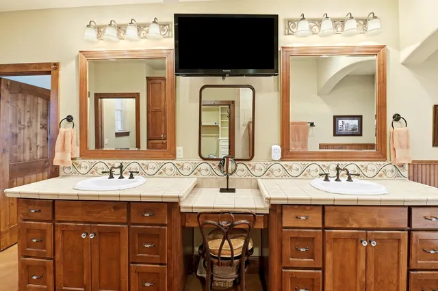 a bathroom with a sink a large mirror and a vanity