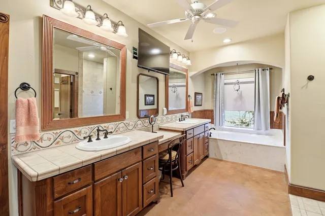 a spacious bathroom with a sink vanity and a mirror