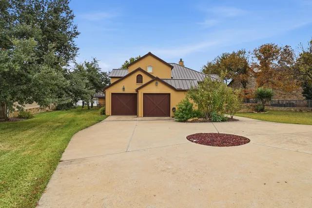 a front view of a house with a yard and a garage