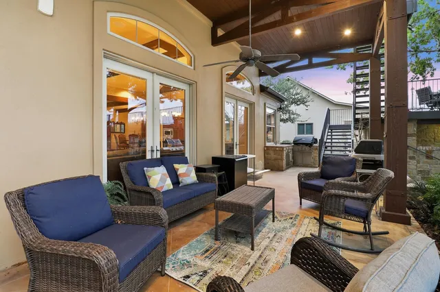 a living room with furniture a rug and a chandelier