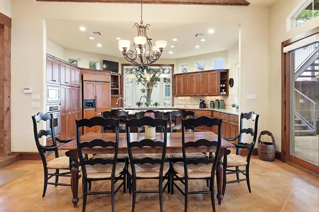 a view of a dining room with furniture and chandelier