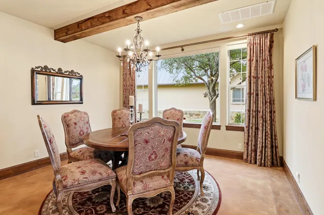 a view of a dining room with furniture a chandelier and wooden floor