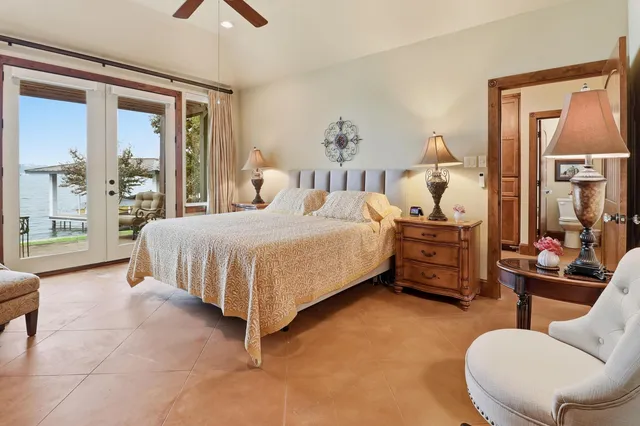 a bedroom with a bed and glass windows