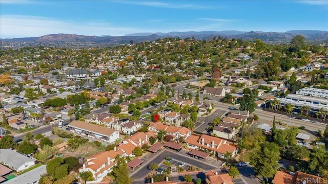 an aerial view of residential building with parking and yard