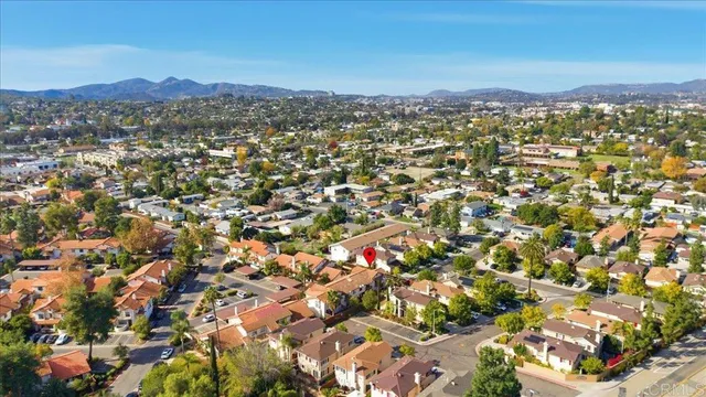 an aerial view of residential houses with city view