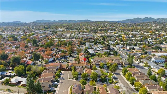 an aerial view of residential houses with city view